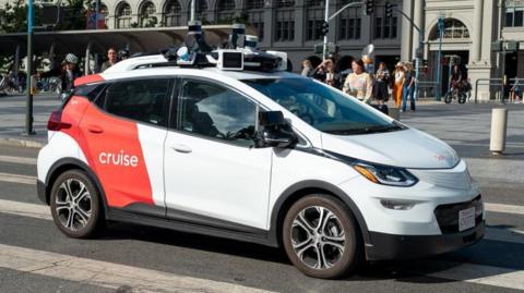 A General Motors Cruise self-driving car, often referred to as a robotaxi, drives in front of the Ferry Building on the Embarcedero, San Francisco, California, 17 August, 2023.