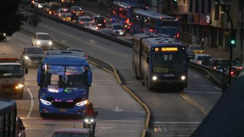 Buses, cars and motorbikes travelling on a main road in Quito during a power outage in Ecuador