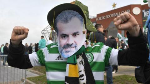 Celtic fan wearing an Ange Postecoglou mask