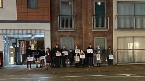 A previous pro-life vigil opposite the BPAS clinic in London Street, Reading (faces pixelized to protect the identities of children). Several people stand holding placards.