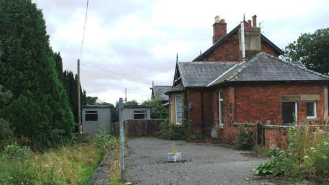 Forge Valley Railway Station, a red brick station building which looks derelict