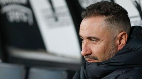 Vitor Pereira sits in a dugout looking into the distance