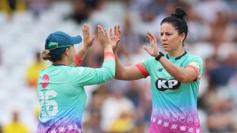 Marizanne Kapp of the Oval Invincibles celebrates taking a wicket with a teammate