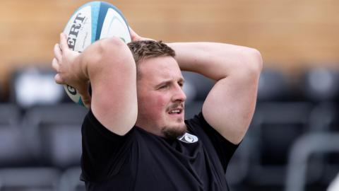 Dafydd Hughes aims a throw-in during training