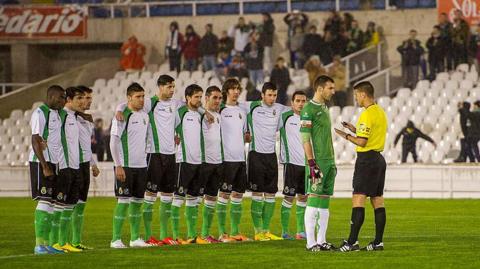 Racing Santander players speak to the referee