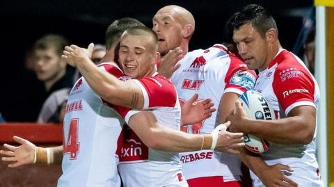 Hull KR players Matt Parcell, Mikey Lewis, Dean Hadley, Tyrone May and Ryan Hall embrace after a try against Salford