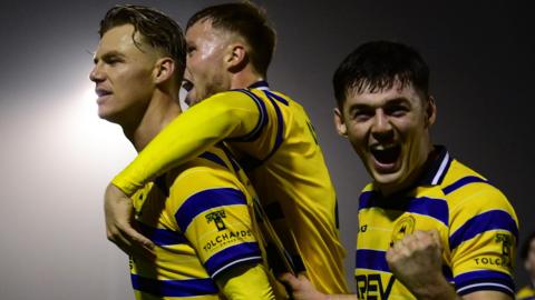 Torquay united platers celebrate a goal