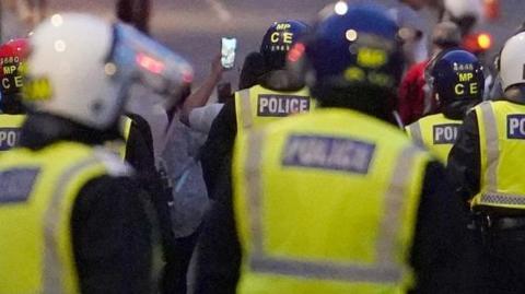 riot police in helmets in London riot