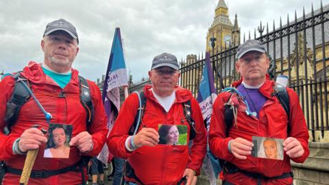 Mike Palmer, Andy Airey and Tim Owen holding pictures of their daughters