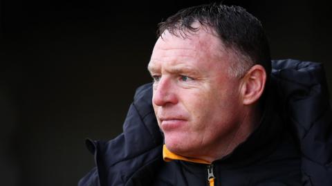 Graham Coughlan watches from the sideline during his time as Newport County boss