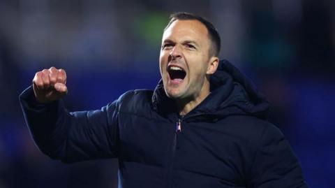 Blues boss Chris Davies punches the air after win against promotion rivals Stockport