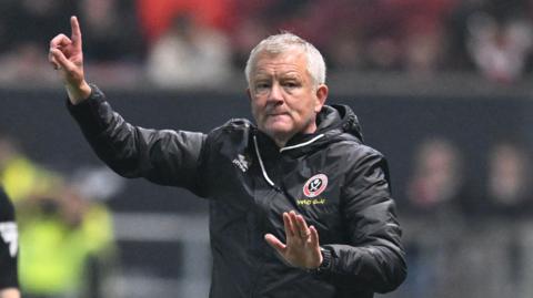 Chris Wilder points upwards