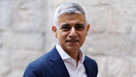 Sadiq Khan in a blue suit and white shirt