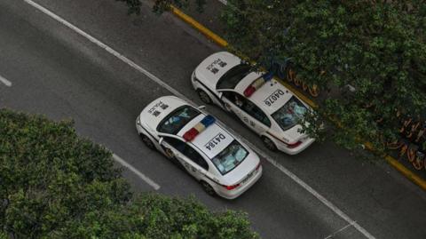 File photo of two police cars in Shanghai