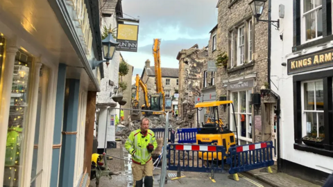 A view down Market Street in Kirkby Lonsdale. Parts of the street have been cordoned off and rubble can be seen from a building affected by the blaze.