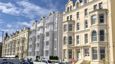 A CGI generated modern six-storey apartment block, with a grey facade and glass balconies, built into a row of six-storey Victorian era cream coloured terraced apartments.