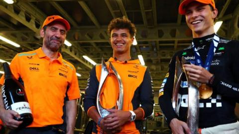 Andrea Stella, Lando Norris and Oscar Piastri hold trophies after winning the Azerbaijan GP