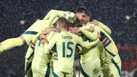 Wales players celebrate their first goal