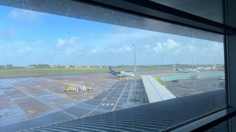 A view of Guernsey's runway from the terminal. Planes are parked in the foreground