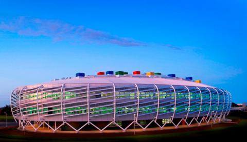 Monkseaton High School. It is a colourful, oval-shaped futuristic-looking building with multi-coloured bricks on its roof.