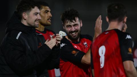 Truro City players celebrate a win