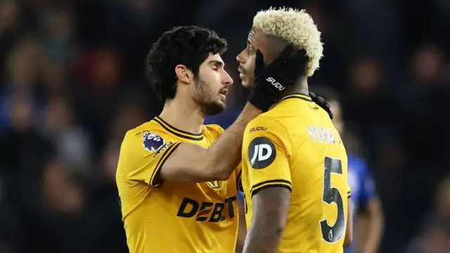 Goncalo Guedes of Wolves speaks with team-mate Mario Lemina