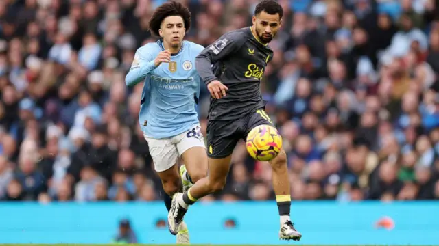 Rico Lewis of Manchester City pursues Everton forward Illiman Ndiaye