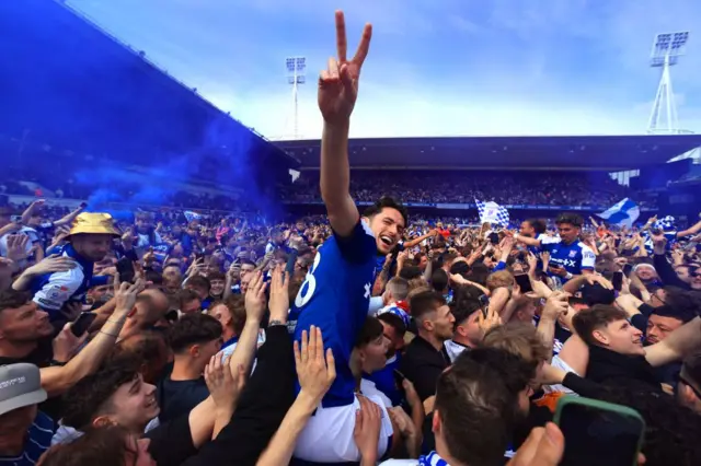 Ipswich players celebrate on the pitch with fans at Portman Road