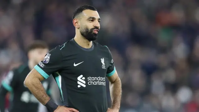 Mohamed Salah looks on with hands on hips