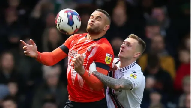 Luton striker Carlton Morris battles with Stoke defender Ben Wilmot during the Potters' 1-0 defeat at Kenilworth Road in February 2023