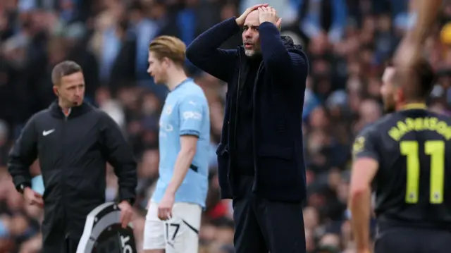 Pep Guardiola with his hand on his head during Manchester City's Premier League draw with Everton