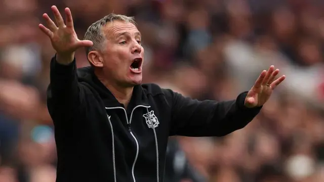 Wrexham boss Phil Parkinson gives instructions to his players