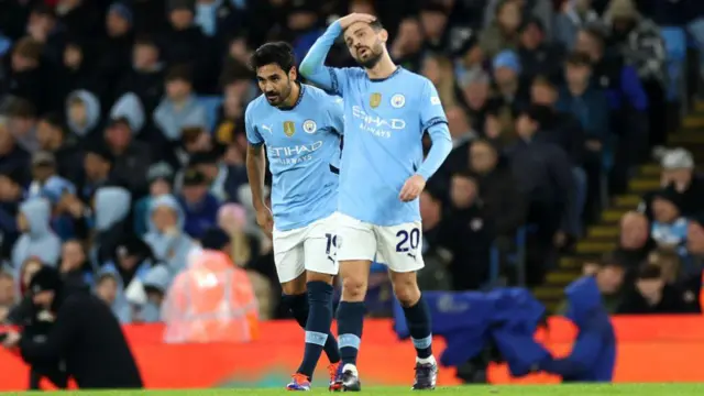 Ilkay Guendogan and Bernardo Silva of Manchester City look dejected after James Maddison of Tottenham Hotspur (not pictured) scores his team's first goal during the Premier League match between Manchester City FC and Tottenham Hotspur.