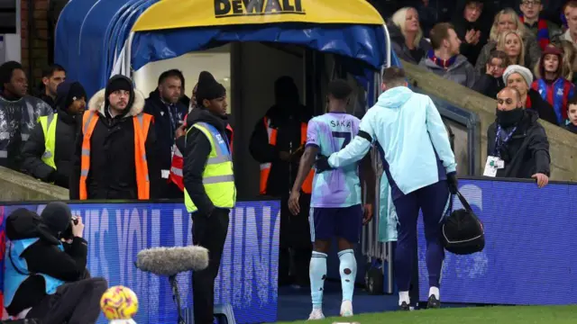 A general view as Bukayo Saka of Arsenal is assisted as he walks down the tunnel