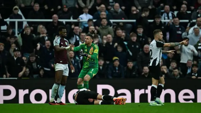 Goalkeeper Martin Dubravka (1) confronts Jhon Duran of Aston Villa (9) after a red car challenge on Fabian Schar