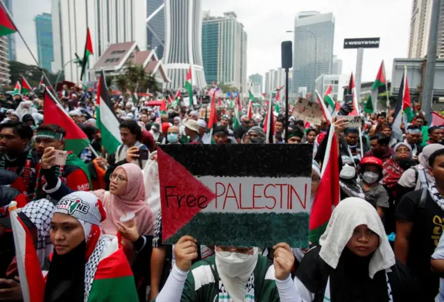 Protesters fly hundreds of Palestinian flags outside the US embassy in Kuala Lumpur