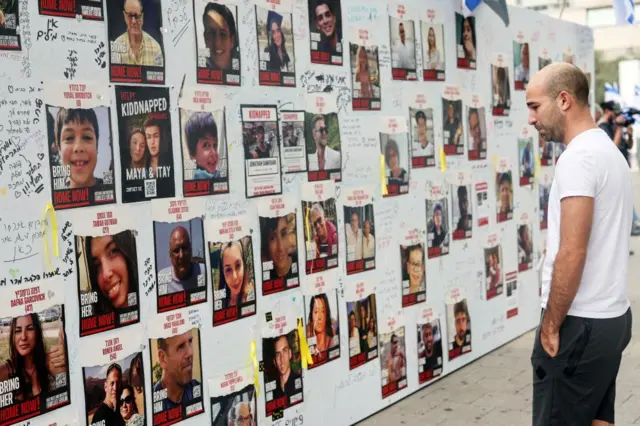 A man looks at missing persons posters in Tel Aviv