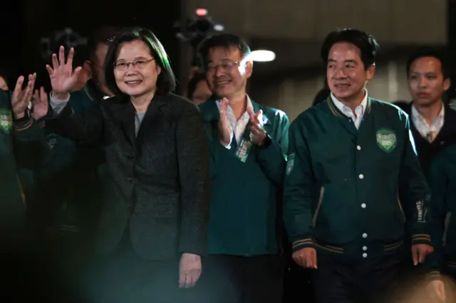 Taiwan's President Tsai Ing-wen (L) waves beside President-elect Lai Ching-te