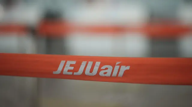 A barricade with the logo of Jeju Air is placed at Muan International Airport, in Muan, South Korea