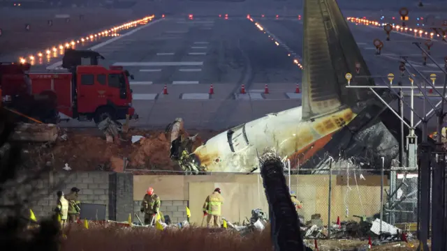 Rescuers work near the wreckage of the Jeju Air aircraft that went off the runway and crashed at Muan International Airport, in Muan, South Korea, December 30, 2024