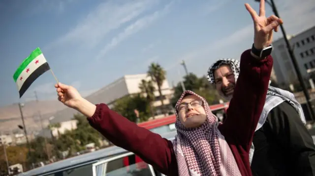 People celebrate in the street after Syrian rebels captured the city of Damascus, in Damascus, Syria, 08 December 2024.