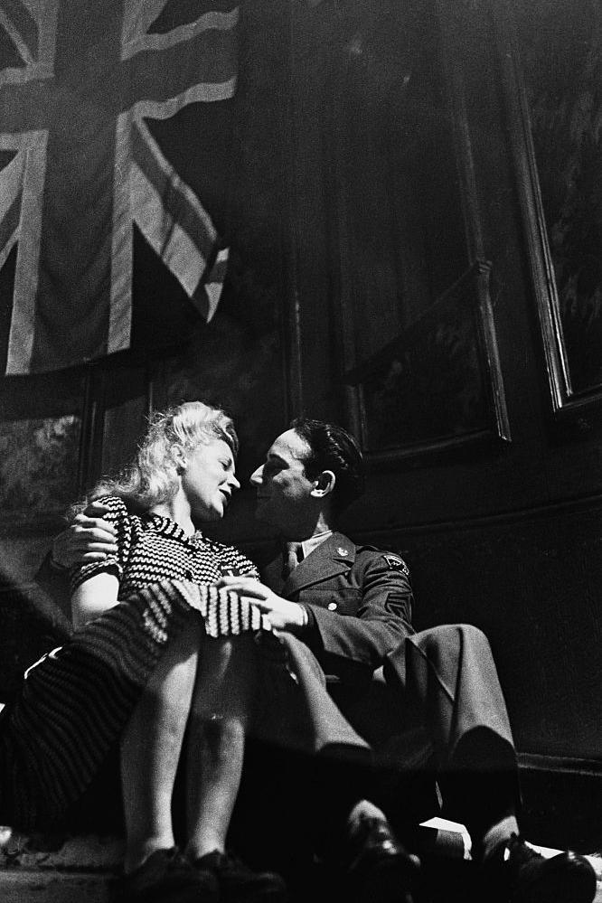 An American soldier and an English girl enjoy a moment of wartime romance at London's Rainbow Corner in January 1944