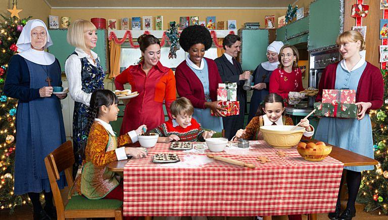 Call the Midwife cast Christmas scene, with characters cooking around a table in a kitchen