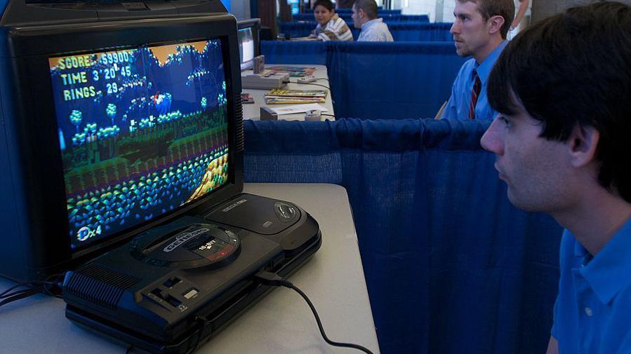 A man playing Sonic the Hedgehog on a Mega Drive