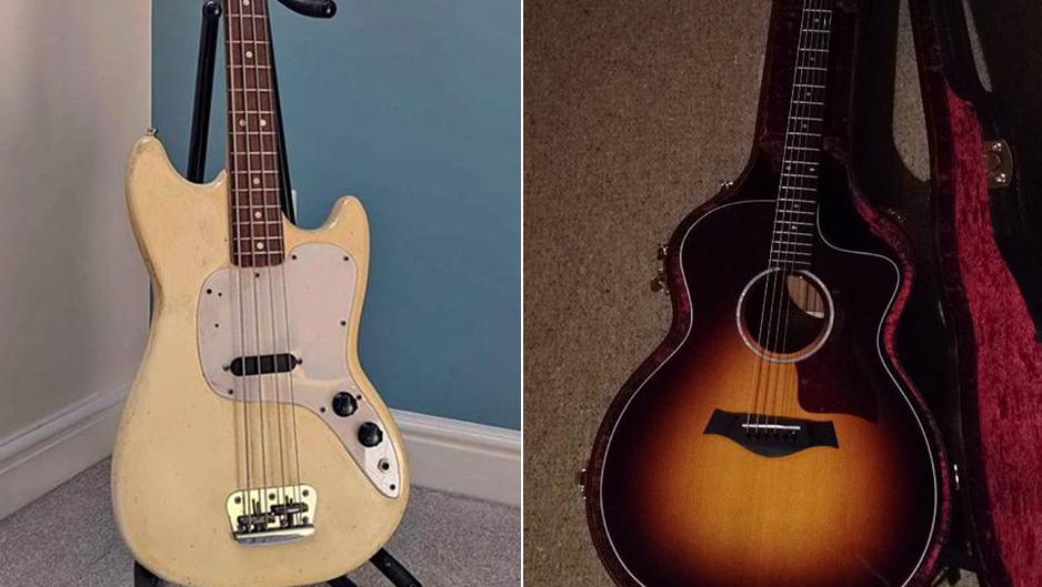 View of two guitars. The one on the right is a beige-coloured bass guitar on a stand, the one on the left is a brown acoustic guitar in an open case with red velvet lining.