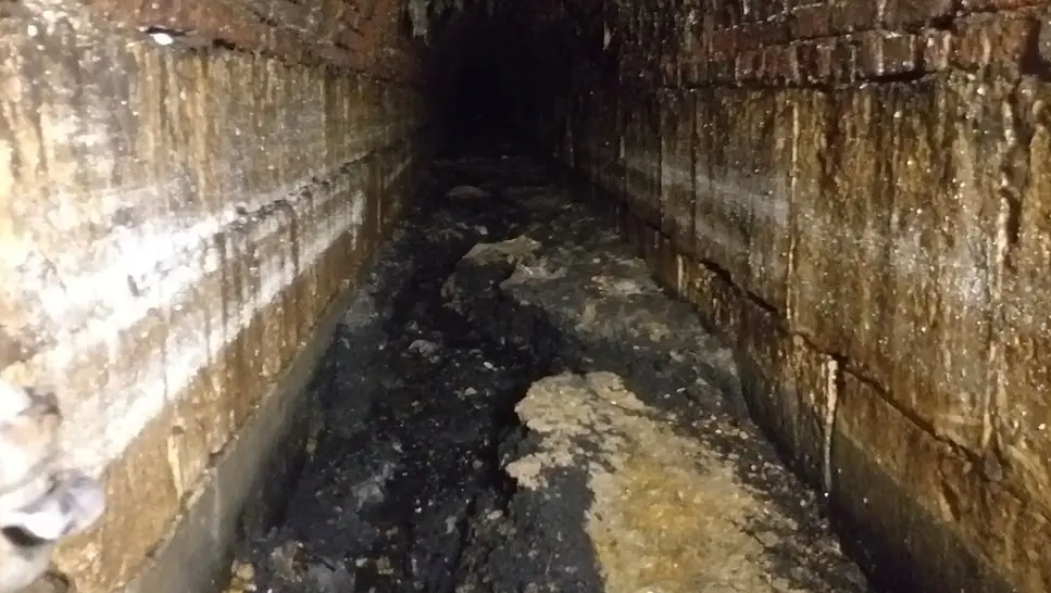 A sewage tunnel filled with fatbergs, a combination of fats, oils, grease, and sanitary items