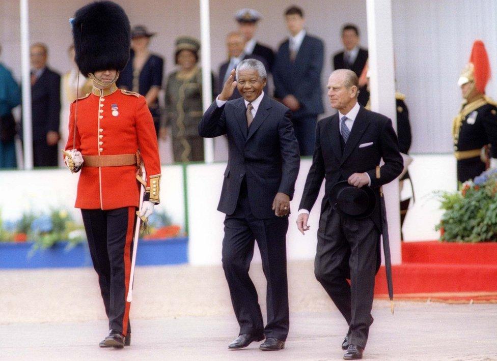 South African President Nelson Mandela, accompanied by the Duke of Edinburgh