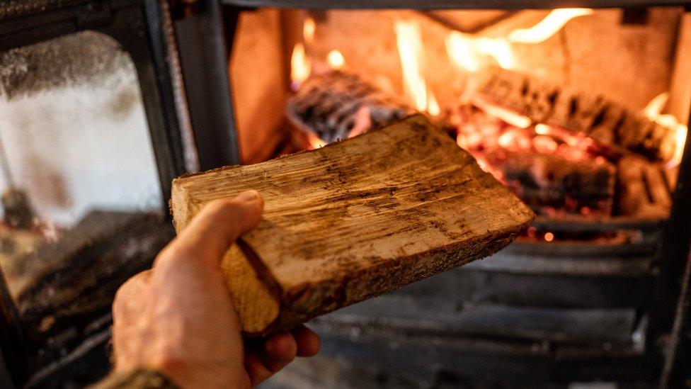 A log being put into a fire