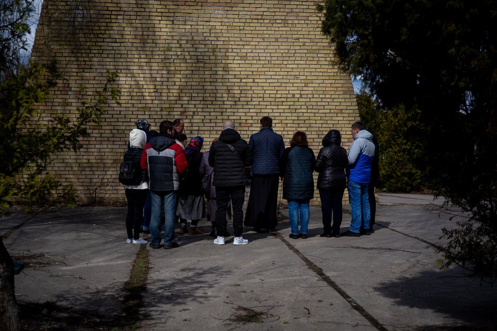 The family gathers for a small funeral service for Vitaliy