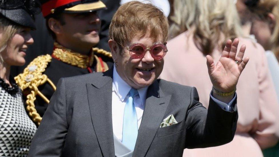 Elton John waving at the crowds